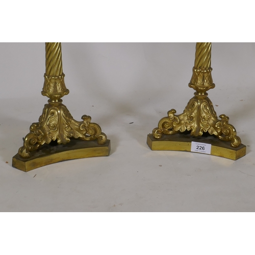 226 - A pair of ormolu five branch candelabra table lamps with twisted columns and scroll supports, 84cm h... 