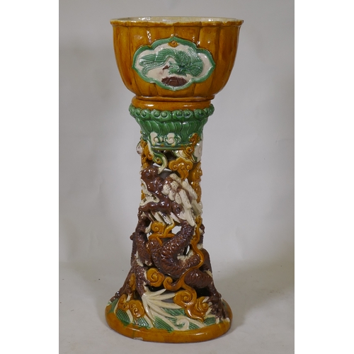 230 - A Chinese Sancai glazed ceramic jardiniere and pierced stand with dragon decoration, 94cm high