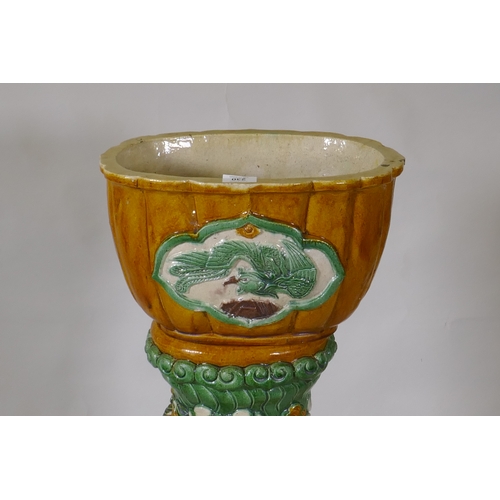 230 - A Chinese Sancai glazed ceramic jardiniere and pierced stand with dragon decoration, 94cm high