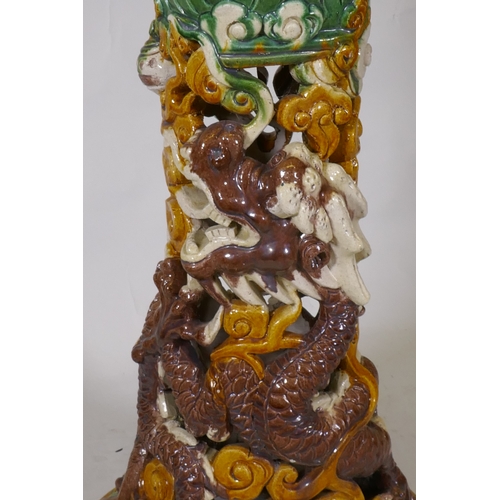 230 - A Chinese Sancai glazed ceramic jardiniere and pierced stand with dragon decoration, 94cm high