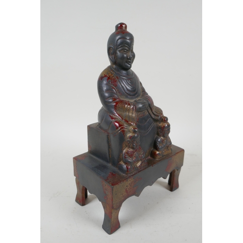 232 - A Chinese cast metal figure of an emperor seated on a throne, with the remnants of gilt patina, char... 