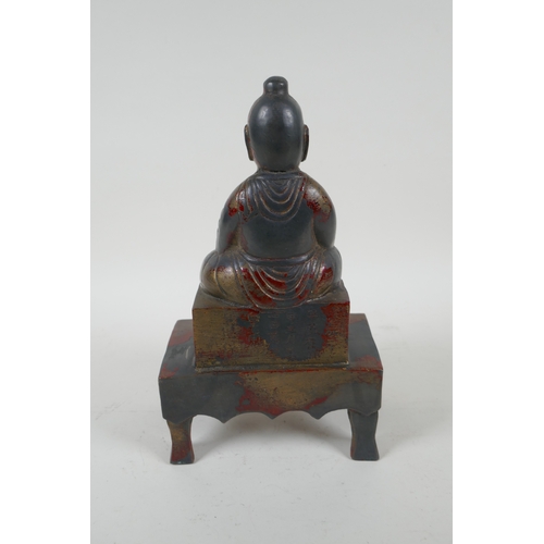 232 - A Chinese cast metal figure of an emperor seated on a throne, with the remnants of gilt patina, char... 