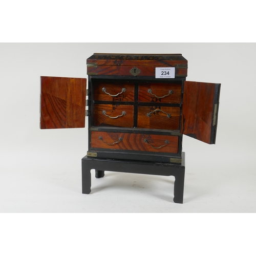 234 - A Meiji lacquered jewellery cabinet on stand with lift up top and four drawers behind two doors over... 