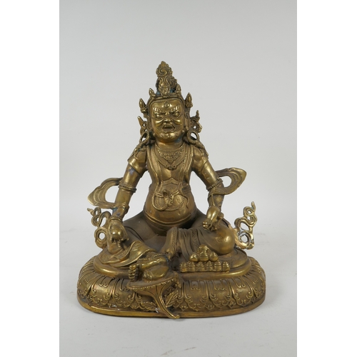 240 - A Tibetan bronze figure of Jambhala, double vajra mark to base, 29cm high