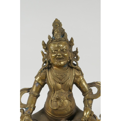 240 - A Tibetan bronze figure of Jambhala, double vajra mark to base, 29cm high