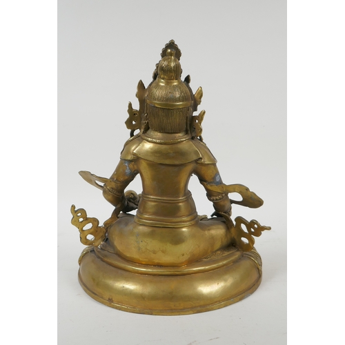 240 - A Tibetan bronze figure of Jambhala, double vajra mark to base, 29cm high