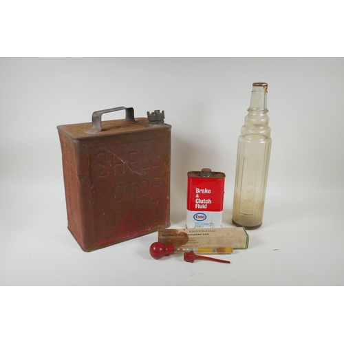 25 - A vintage Shell Motor Spirit petrol can, an Esso one quart glass oil bottle, a can of Esso Brake &am... 