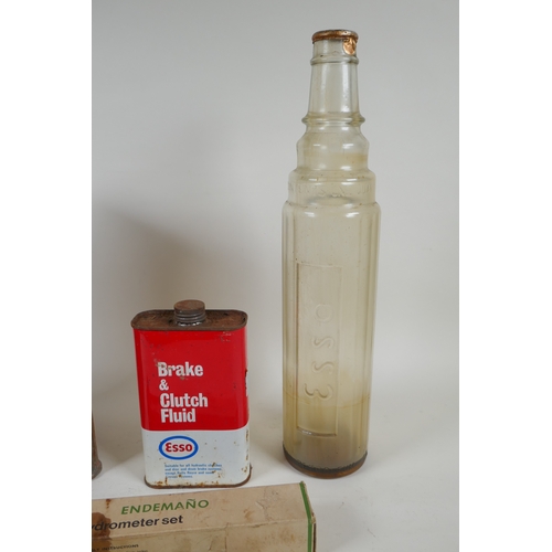 25 - A vintage Shell Motor Spirit petrol can, an Esso one quart glass oil bottle, a can of Esso Brake &am... 