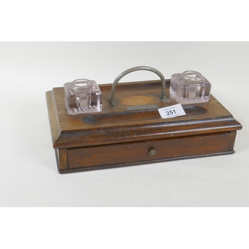 251 - A mahogany desk stand with two glass inkwells and inlaid decoration, bears plaque, present to Miss T... 