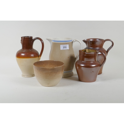 255 - A Doulton Lambeth jug, two lustre jugs, and a Mocha ware jug, 17cm high, and a bowl