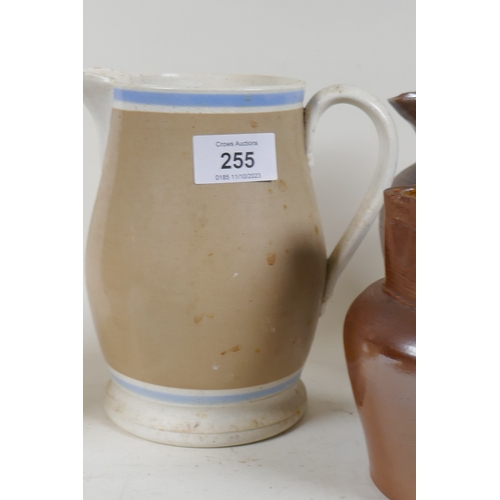 255 - A Doulton Lambeth jug, two lustre jugs, and a Mocha ware jug, 17cm high, and a bowl