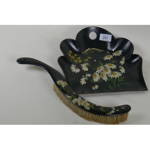 257 - A Victorian papier mache crumb scoop and brush with painted decoration, 25cm long