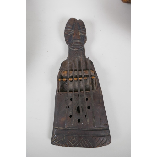 262 - An African antique carved hardwood Kalimba in the form of a figure, together with a carved root wood... 