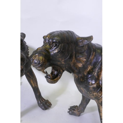 278 - A pair of Chinese bronze life size tiger cubs with the remnants of gilt patina, 114cm long