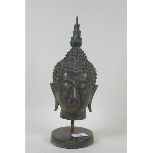 28 - A bronze Buddha's head mounted on a metal stand, 32cm high