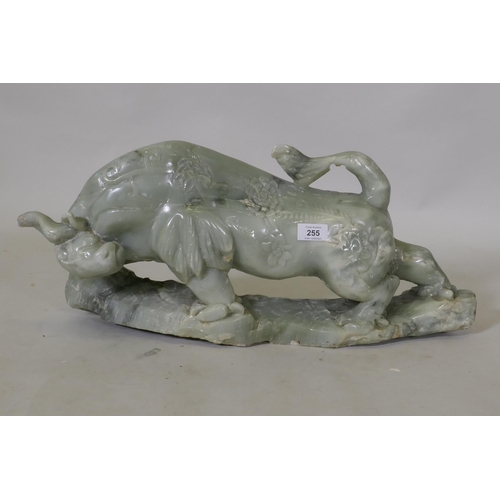 295 - A Chinese carved soapstone figure of a bull, 58 x 28cm