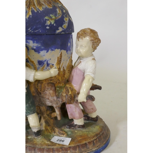 299 - C19th Majolica ceramic centrepiece in the form of three boys with a wheelbarrow, AF, 36cm high