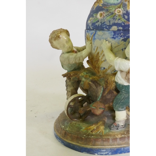 299 - C19th Majolica ceramic centrepiece in the form of three boys with a wheelbarrow, AF, 36cm high