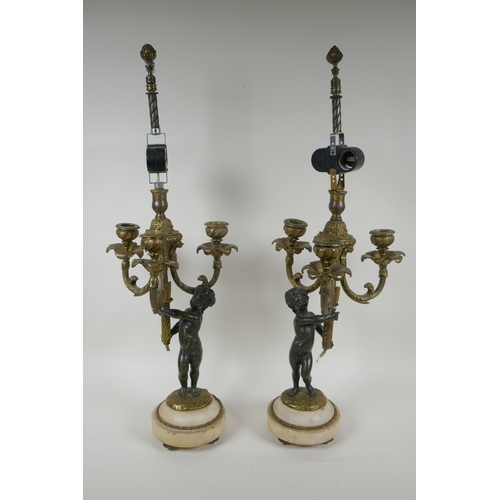 32 - A pair of bronze and ormolu cherub three branch candlesticks converted to a lamp, 60cm high