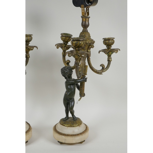 32 - A pair of bronze and ormolu cherub three branch candlesticks converted to a lamp, 60cm high