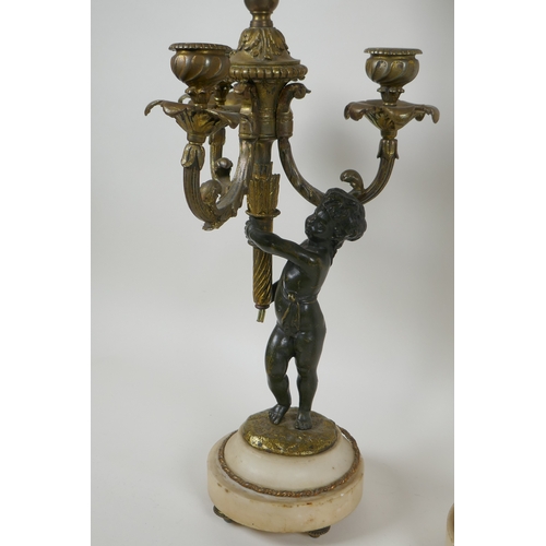 32 - A pair of bronze and ormolu cherub three branch candlesticks converted to a lamp, 60cm high