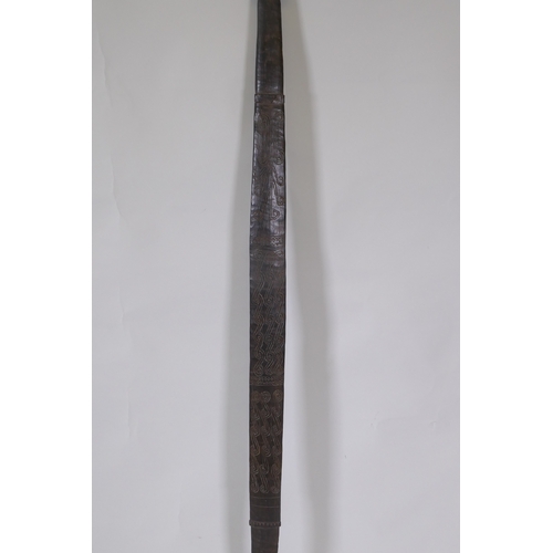 34 - An African carved hardwood ceremonial tribal staff/long sword, 133cm long