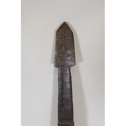 34 - An African carved hardwood ceremonial tribal staff/long sword, 133cm long