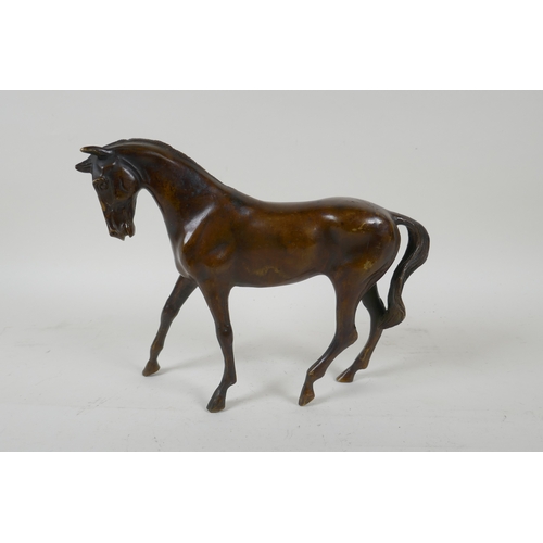 36 - A filled bronze figure of a horse, 24cm long