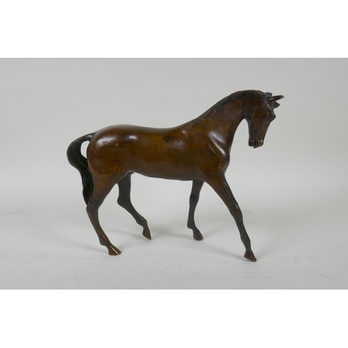 36 - A filled bronze figure of a horse, 24cm long