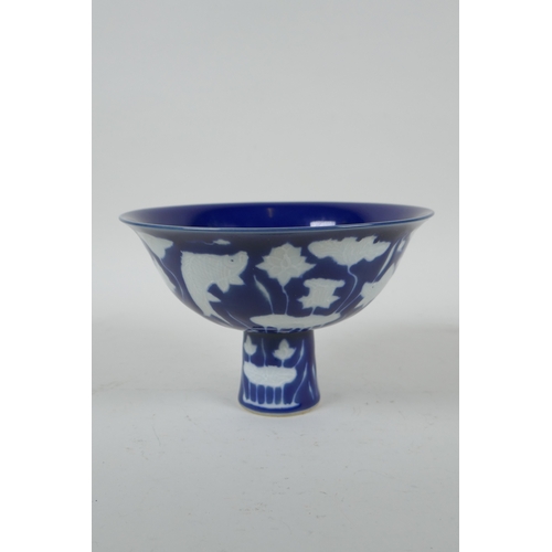 37 - A Chinese sacrificial blue glazed porcelain stem bowl decorated with carp in a lotus pond, Xuande 4 ... 