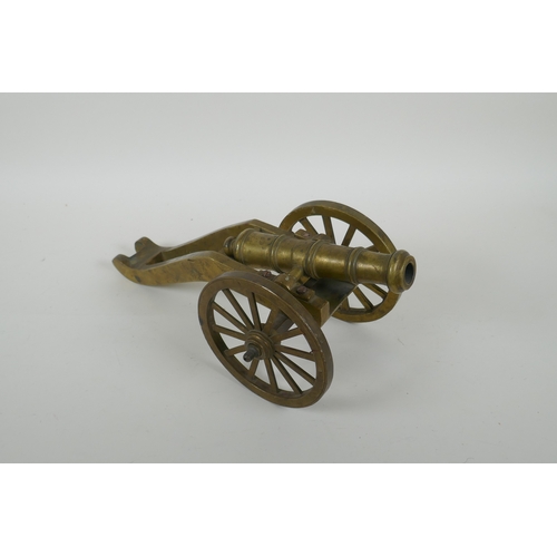 39 - An antique bronze table canon, 33cm long, AF missing wheel nuts