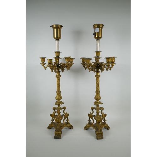 46 - A pair of French ormolu five branch candlesticks on a tripod base with griffin decoration, the centr... 