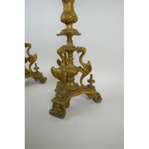 46 - A pair of French ormolu five branch candlesticks on a tripod base with griffin decoration, the centr... 