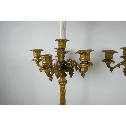 46 - A pair of French ormolu five branch candlesticks on a tripod base with griffin decoration, the centr... 