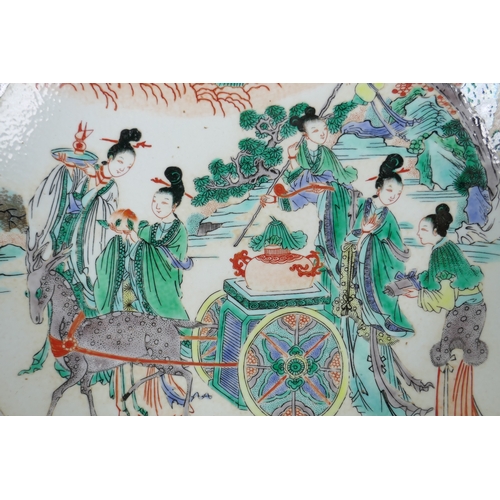 48 - A Chinese KangXi style famille vert porcelain charger decorated with female travellers and deer draw... 