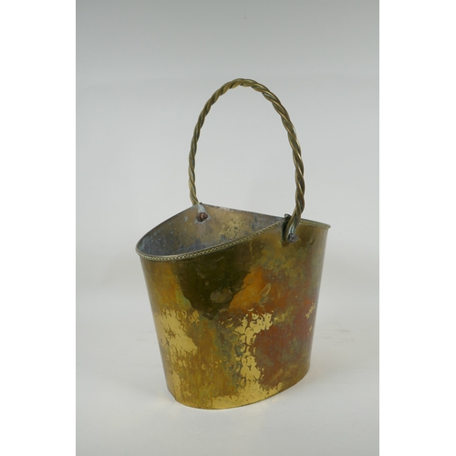 49 - An antique brass ice bucket with a braided handle, 30 x 21cm