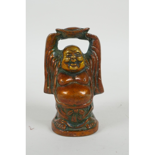 56 - A Sino Tibetan bronze figure of a jolly Buddha, and a bronze four faced Buddha head, largest 9cm hig... 