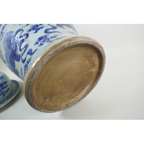 58 - A Chinese blue and white porcelain jar and cover, decorated with kylin, 53cm high