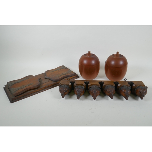 6 - An antique Black Forest carved wood pipe rack with bear's head decoration, a pair of turned wood tob... 