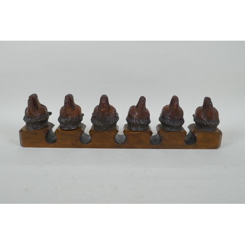 6 - An antique Black Forest carved wood pipe rack with bear's head decoration, a pair of turned wood tob... 