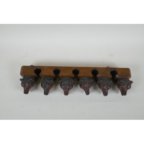 6 - An antique Black Forest carved wood pipe rack with bear's head decoration, a pair of turned wood tob... 