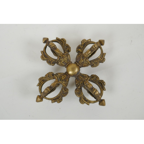 64 - A Tibetan gilt metal double vajra, 15 x 15cm