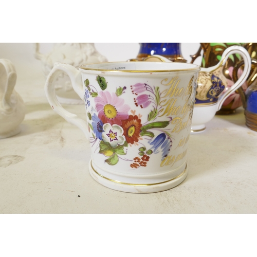 67 - A C19th creamware mug, with hand painted floral decoration and inscription in gilt, 9cm high, and a ... 