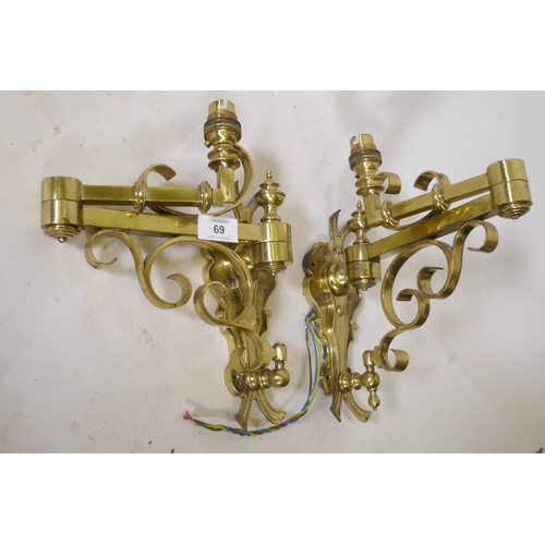 69 - A pair of brass two fold wall sconces, 25cm high, 36cm extended