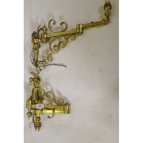 69 - A pair of brass two fold wall sconces, 25cm high, 36cm extended