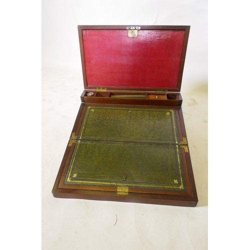 70 - A C19th mahogany campaign writing slope with brass mounts and military style carrying handles, the i... 