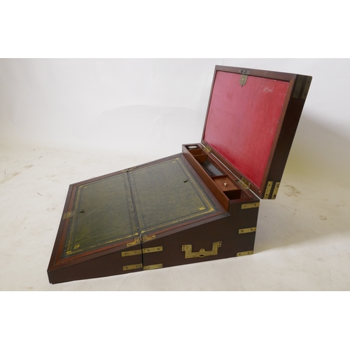 70 - A C19th mahogany campaign writing slope with brass mounts and military style carrying handles, the i... 