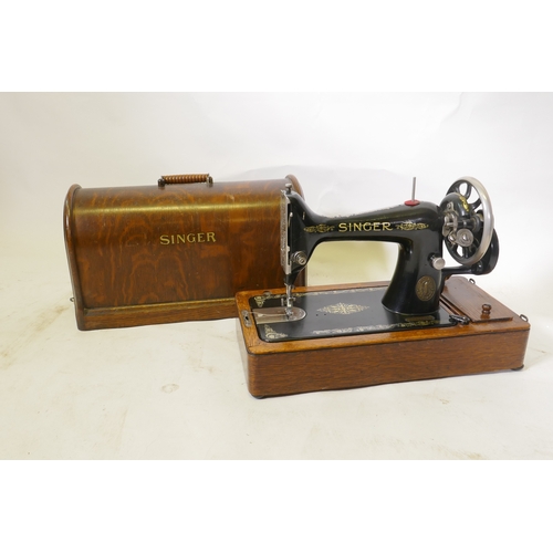 84 - A Singer hand cranked sewing machine, No F6515489, in an oak case