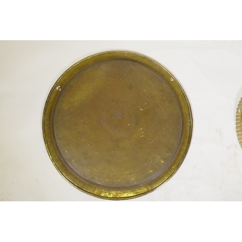 90 - An Islamic brass tray with script decoration, together with another larger decorated with Islamic sc... 