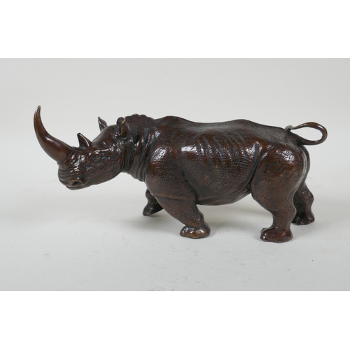 93 - A filled bronze rhinoceros, 23cm long